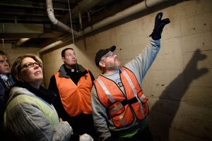 The Rev. Donald Love (right), pastor of Calvary Lutheran Church in Watseka, Ill., points out flood damage in a home to (from left) Laura Amidon of Mount Pulaski, Ill.; Traci Grever of Palatine, Ill.; and the Rev. Michael Meyer, manager of LCMS Disaster Response, during a Jan. 9 volunteer cleanup event for flood-damaged homes in Watseka. (LCMS/Erik M. Lunsford)