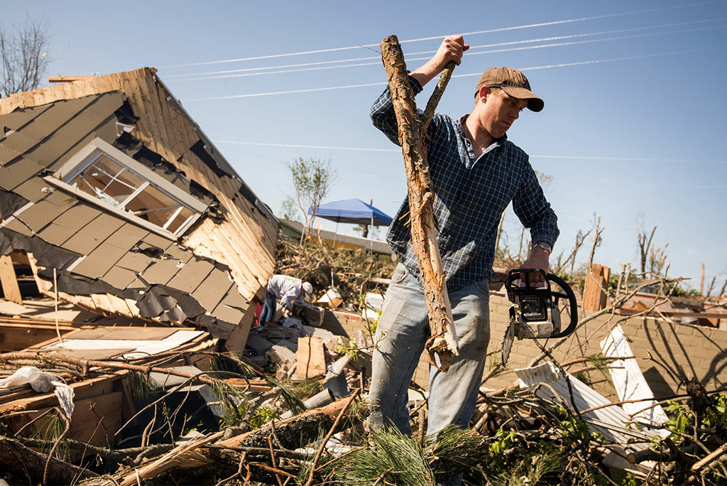 John Gorman removes debris from a tornado-destroyed home in Tupelo, Miss., on May 2, 2014. "LCMS Camp Courage: A Place of Hope and Healing" — a weeklong vacation Bible school program designed to help traumatized children rebound from disasters — is the Synod's latest "crowdfunding" project. Its goal is to raise a total of $6,430 by June 14. (LCMS/Erik M. Lunsford)