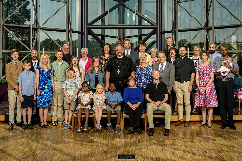 New overseas missionaries — who will be serving in 11 countries — pose for a group photo with LCMS President Rev. Dr. Matthew C. Harrison, center, during the June 13-24 orientation at the Synod's International Center in St. Louis. (LCMS/Erik M. Lunsford)