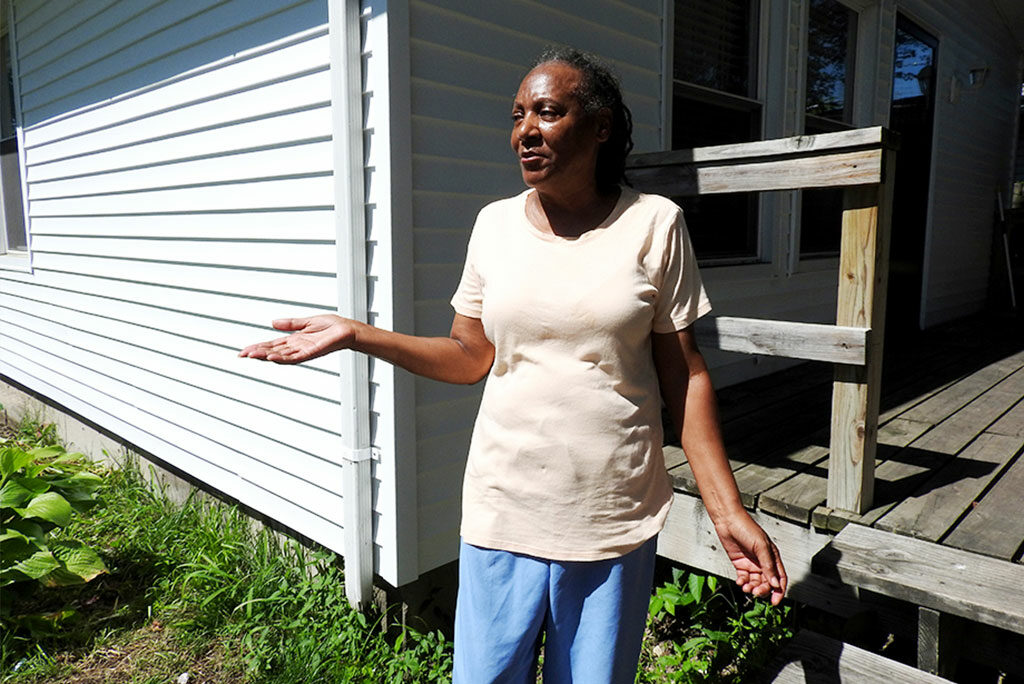 Betty Harris shows off the new siding on her East St. Louis home, made possible by a Lutheran Housing Support initiative that provides resources to congregations and community partners to assist low-income, disabled or elderly homeowners. (LCMS/Joe Isenhower Jr.)