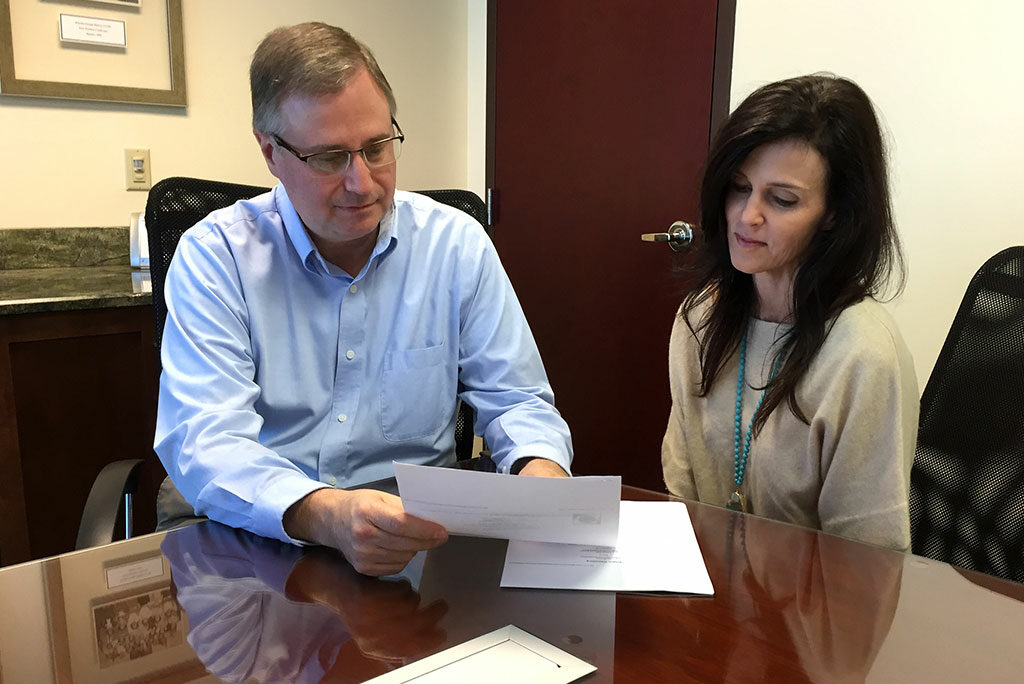 The LCMS Florida-Georgia District is saving $2,000 in annual fees since moving from a commercial bank to the Lutheran Federal Credit Union, says district Business Manager John Elliott, going over paperwork with bookkeeper Laura Zirbel. He calls the savings “money we can now use for the district’s mission to serve, assist and encourage congregations in the ministry of Jesus Christ.” (LCMS Florida-Georgia District)