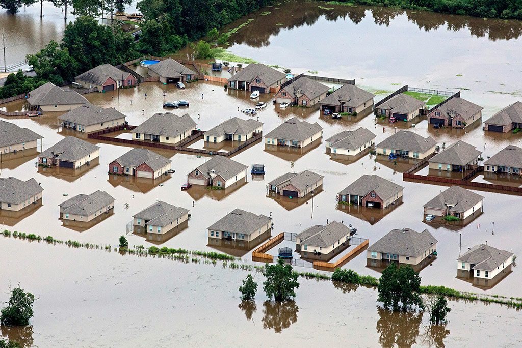 In this aerial photo over Hammond, La., flooded homes are seen off of LA-1064 after heavy rains inundated the region Aug. 13. (AP Photo/Max Becherer)