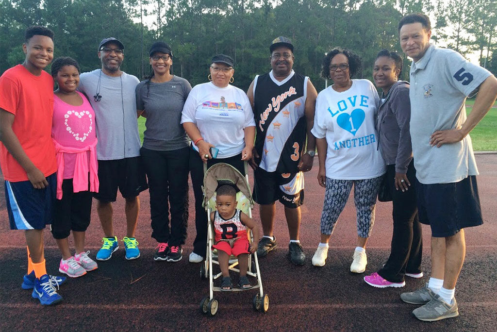 The Rev. James Wiggins Jr. and his wife, Loretta (third and fourth from left), pose with other "Walk with the Pastor" participants in July on the track at Florida State College of Jacksonville (Fla.). Wiggins, pastor of St. Paul Lutheran Church, Jacksonville, says he enjoys the fellowship of the early-morning walks. "It's really a great time to not only get to know your members and leaders better, but it also allows you to meet other citizens from the community," he told Reporter. (Courtesy of James Wiggins Jr.)