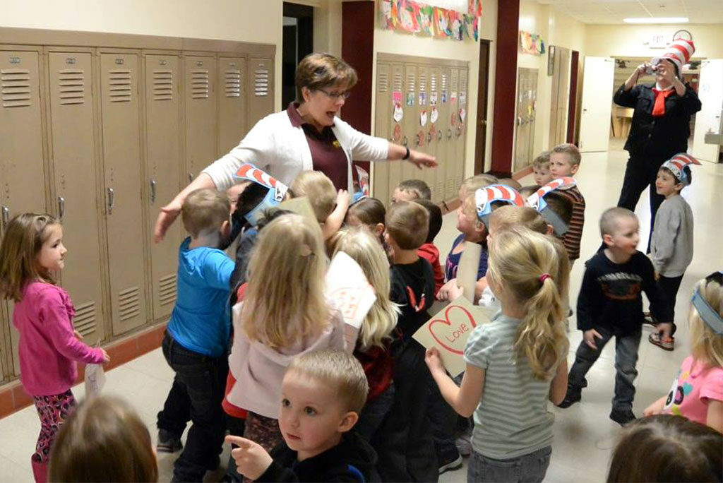 Susan Longmire, principal of St. James Lutheran School in Shawano, Wis., gets a birthday hug in March from 3-year-old preschool students. Longmire will be honored in Washington, D.C., in October as one of the nation’s best elementary school principals. (Kim Klement) 