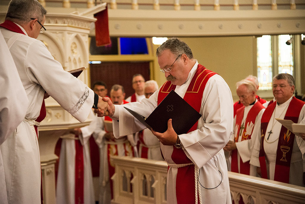 LCMS President Rev. Dr. Matthew C. Harrison shakes hands with Missouri District President Rev. Dr. R. Lee Hagan, as Harrison is installed to be Synod president for the next triennium. Harrison was elected to a third, three-year term as LCMS president earlier this year. 