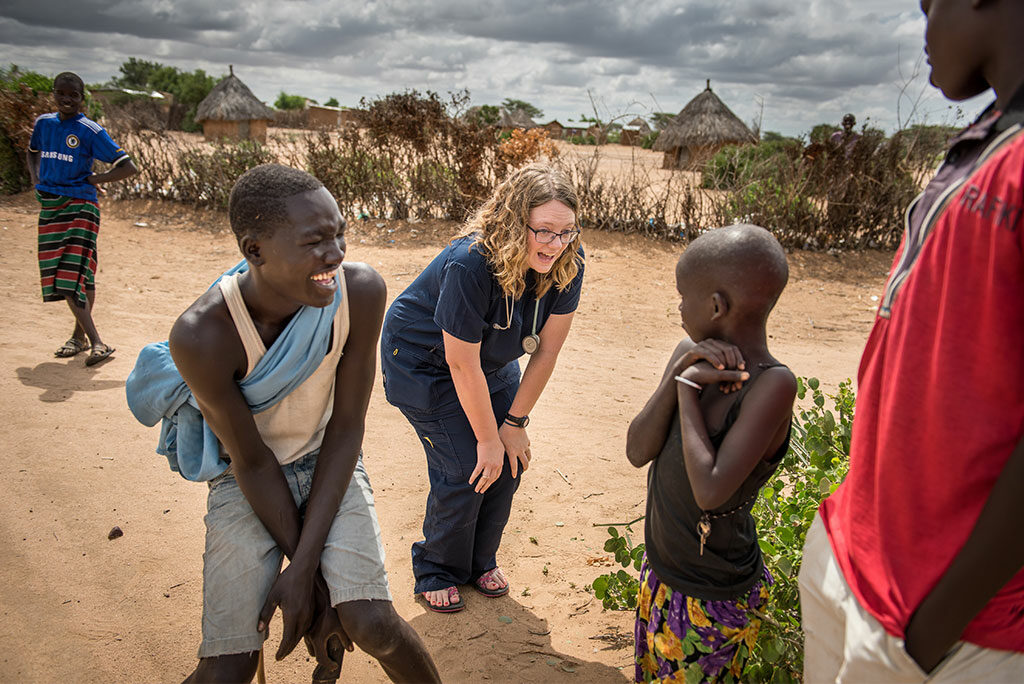 Sarah Kanoy, a nurse and career missionary in East Africa, greets children before the first day's clinic.