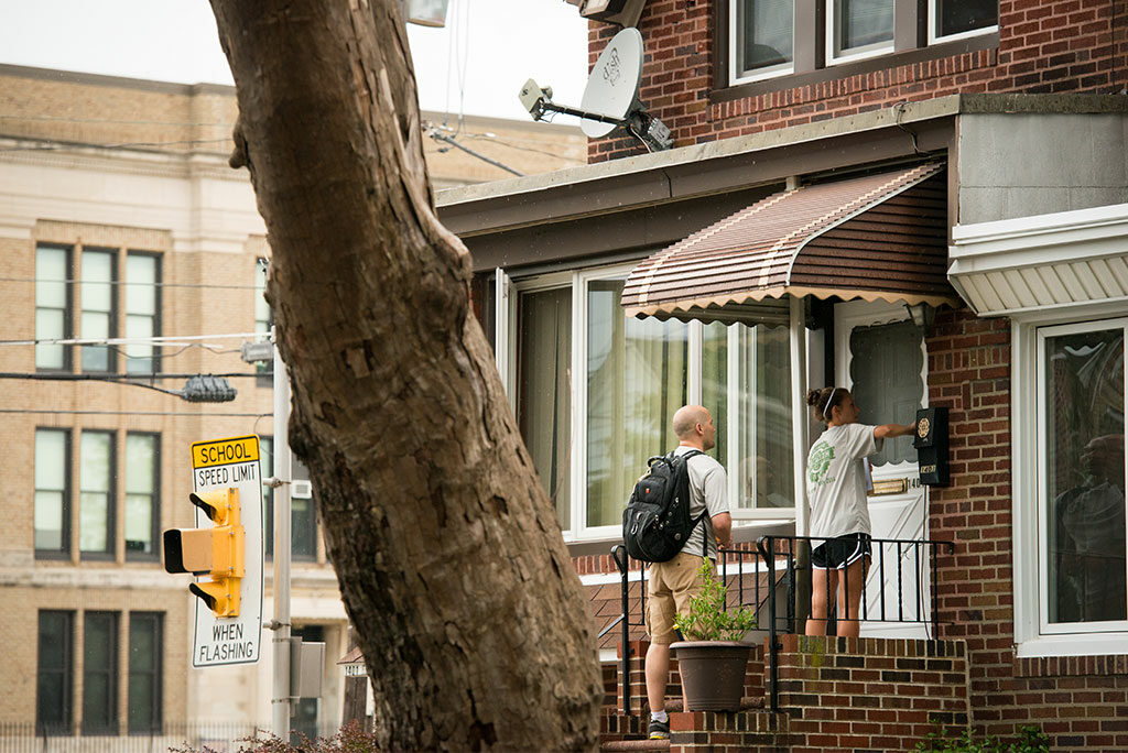 The Rev. Mark Kiessling, director of LCMS Youth Ministry, joins Kalli Parauka on the 2014 Lutheran Young Adult Corps pilot project as they knock on doors during a Gospel Seeds training session in Philadelphia. The online application process for the Synod’s new young-adult ministry opens Oct. 10. (LCMS/Erik M. Lunsford)