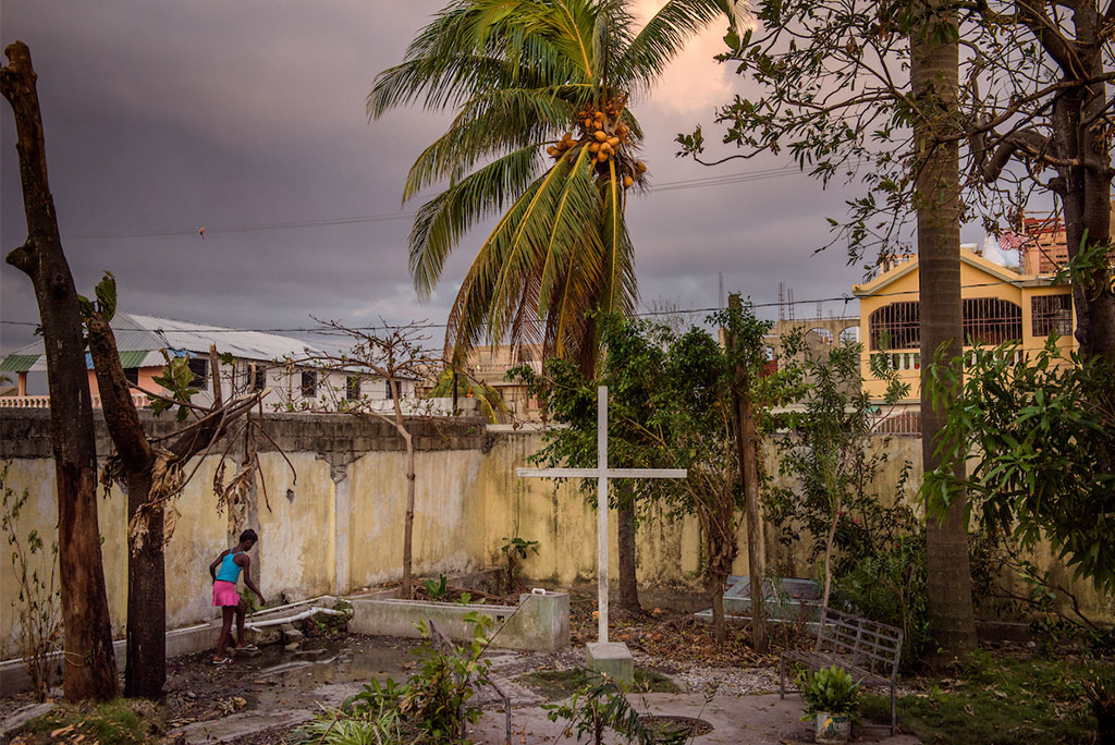 A young woman walks to the water well amid fallen debris from Hurricane Matthew in the entranceway to First Lutheran Church of Les Cayes in Haiti, Oct. 11. LCMS Disaster Response is working to provide an initial 10 wells, with a goal of providing up to 50 wells for clean water amid an outbreak of cholera that followed the hurricane. (LCMS Communications/Erik M. Lunsford)