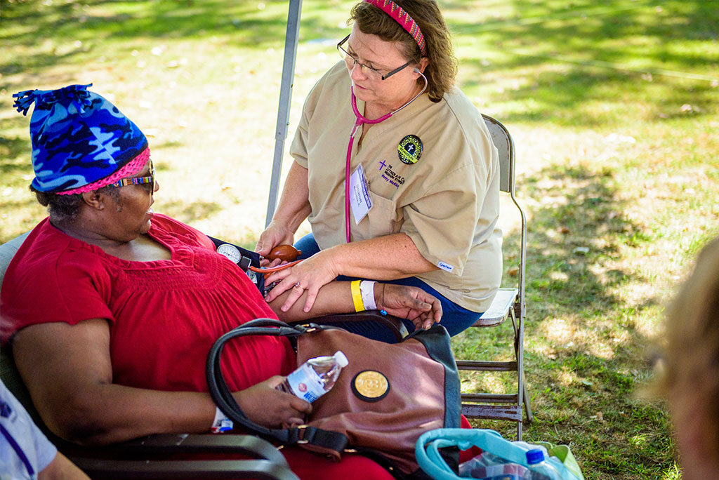 Sharon Thomas, a nurse from Belvidere, Ill., and board chair of Lutherans in Medical Missions, takes a woman's blood pressure during the Synod’s first domestic Mercy Medical Team health fair Aug. 26-27 at Shepherd of the City Lutheran Church in Philadelphia. (LCMS/Erik M. Lunsford)