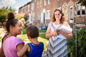 Deaconess Melissa DeGroot meets neighborhood children near Shepherd of the City Lutheran Church in Philadelphia as she distributes fliers for the domestic Mercy Medical Team event there Aug. 26-27. (LCMS/Erik M. Lunsford)