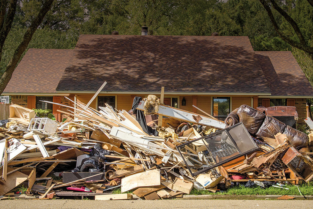 A home affected by August flooding is shrouded behind a curb full of debris Sept. 13 in Baton Rouge, La. More than 600 volunteers at Camp Restore—Baton Rouge, established with a grant from LCMS Disaster Response, have helped in the cleanup of 200-plus flood-damaged homes.