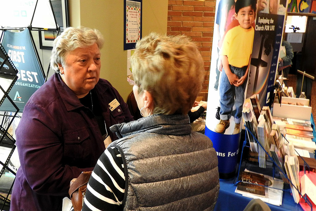 Virginia Flo, Lutherans For Life (LFL) regional director of Minnesota and national conference director, speaks with a conference participant during a break at the 2016 LFL National Conference at St. Michael’s Lutheran Church in Bloomington, Minn. (LCMS/Roger Drinnon)