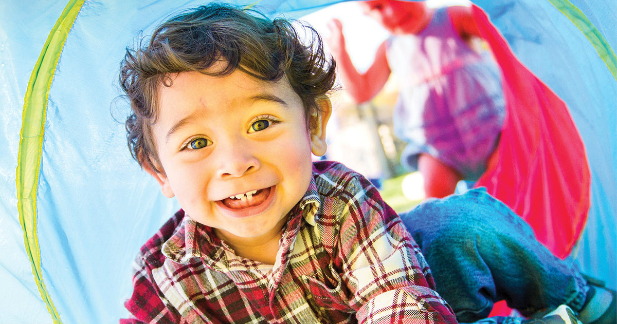 Xavier crawls through a play tunnel at ACTS of Love Early Childhood Education Center in Leander, Texas. (LCMS/Erik M. Lunsford)