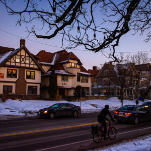 A bicyclist pedals past the Luther House (left) near the University of Minnesota on Feb. 21, 2018. (LCMS/Erik M. Lunsford)