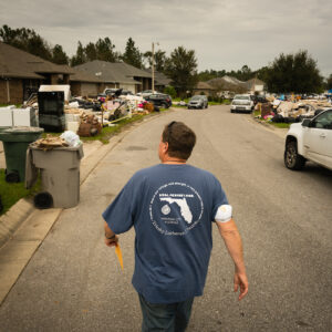 The Rev. Paul McComack (center), pastor of Trinity Lutheran Church, Panama City, Fla., walks Tuesday, Sept. 22, 2020, through a neighborhood in Pensacola, Fla., that was flooded in the aftermath of Hurricane Sally. He and other volunteers from Trinity setup an outreach kitchen and offered meals to storm victims and those helping in the cleanup. LCMS Communications/Erik M. Lunsford