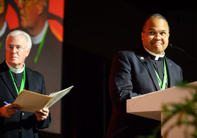 Oklahoma District President Rev. David R. Nehrenz, chairman of Floor Committee 1 (left), and Atlantic District President Rev. Dien A. Taylor, an advisory ordained member of Floor Committee 1 (right), present Res. 1-02A to the floor during the committee’s July 31 presentation to the 68th Regular Convention of the LCMS in Milwaukee. (LCMS/Frank Kohn)