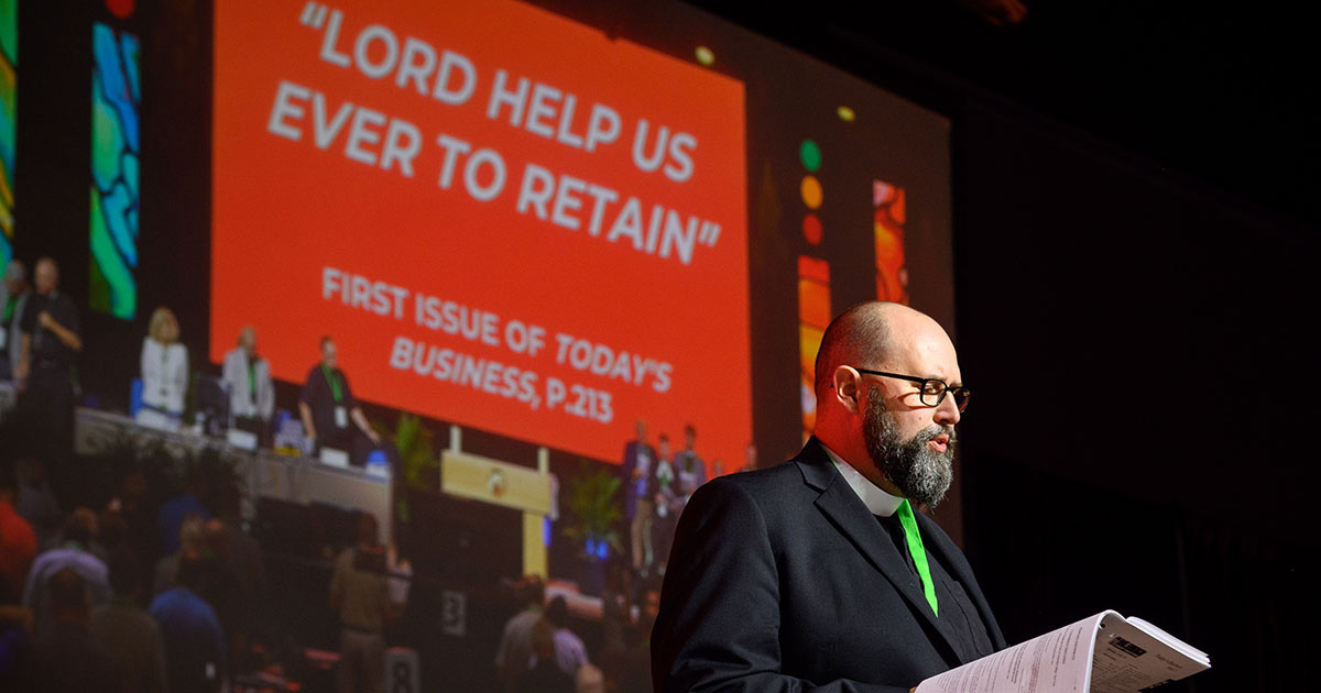 The Rev. Benjamin Ball, Floor Committee 12 chairman and newly elected LCMS second vice-president, leads the assembly in singing “Lord, Help Us Ever to Retain” in honor of Lutheran schools. (LCMS/Frank Kohn)