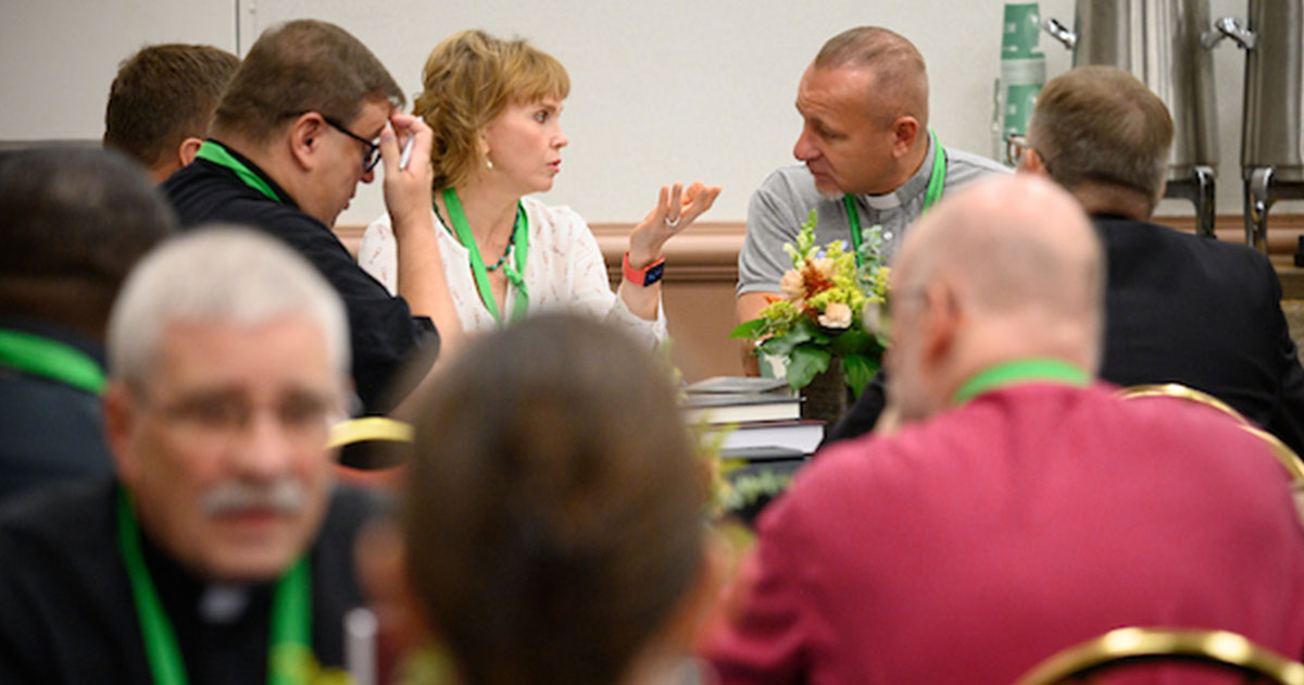 The Rev. Serge Maschewski (center right), bishop of the Evangelical Lutheran Church of Ukraine, listens to a translator during the International Church Relations Forum on Tuesday, Aug. 1. (LCMS/Roy S. Askins)
