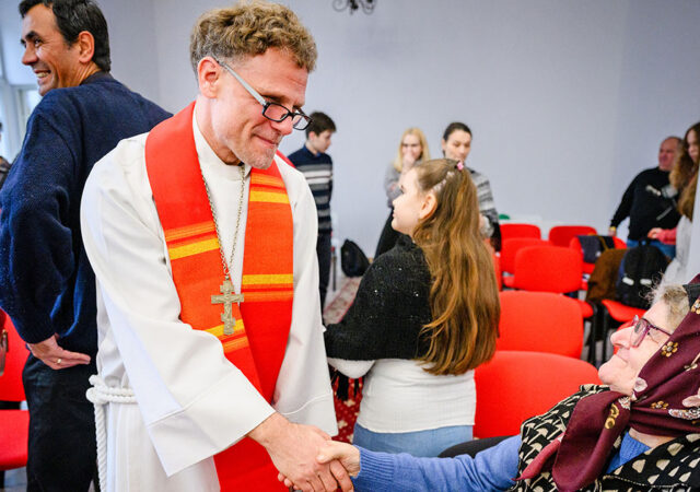 The Rev. Dr. David Preus greets attendees following Divine Service at the Confessional Lutheran Church in Romania’s St. Mary’s Lutheran Center in Braşov, Romania, in 2024.