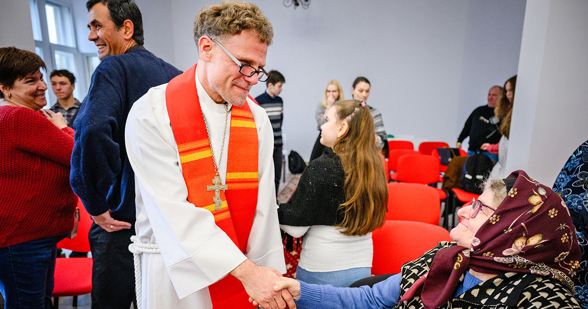 The Rev. Dr. David Preus greets attendees following Divine Service at the Confessional Lutheran Church in Romania’s St. Mary’s Lutheran Center in Braşov, Romania, in 2024.