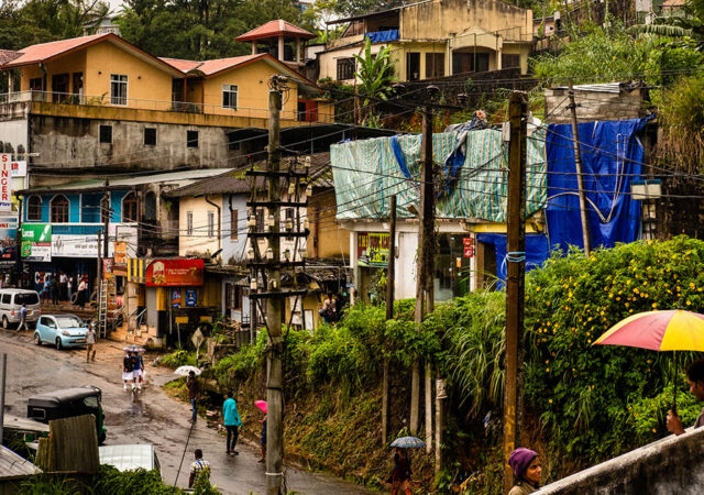 The Rev. G. Nadaraja, pastor of Good Shepherd Lutheran Church in Westward Ho, Sri Lanka, presents a child with a school packet in January. (M. Anton)