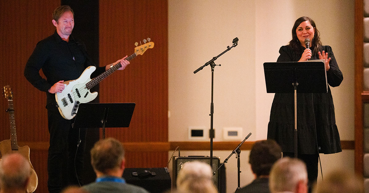 Erin Bode speaks to the audience at her concert held on Monday evening, July 20, during the 69th Regular Convention of The Lutheran Church—Missouri Synod in Phoenix. Also pictured is bassist Jordan Davis. (LCMS/Erik M. Lunsford)