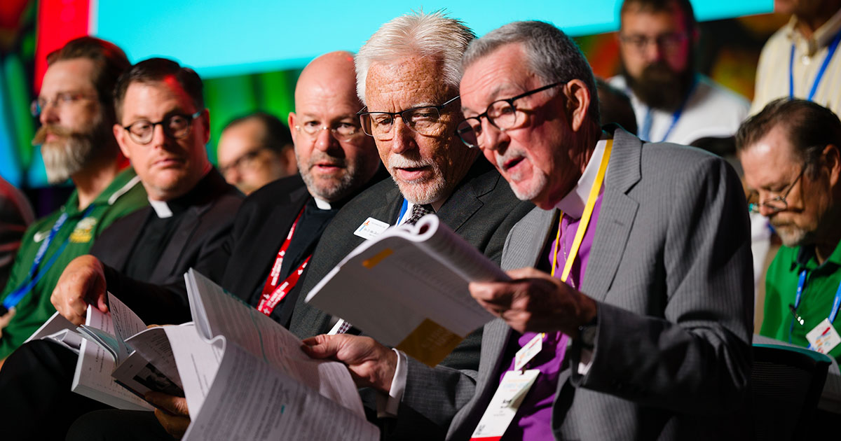 The Rev. Dr. Mike Gibson, president of the LCMS Pacific Southwest District, confers with the Rev. Dr. Scott Murray, outgoing LCMS third vice-president, as part of Floor Committee 6 on Pastoral Ministry and Seminaries during the 69th Regular Convention of The Lutheran Church—Missouri Synod in Phoenix on Monday, July 20. (LCMS/Erik M. Lunsford)