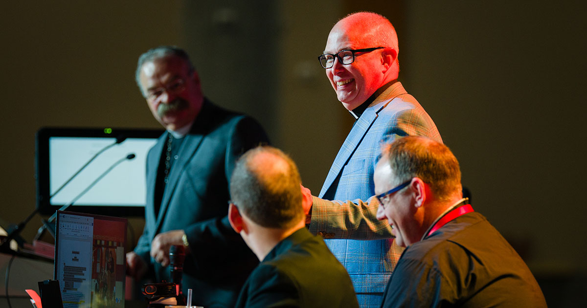 The Rev. Dr. John W. Sias shares a lighthearted moment with LCMS President Rev. Dr. Matthew C. Harrison during convention business on July 20. Sias was elected to a fourth term as Synod secretary. (LCMS/Erik M. Lunsford)