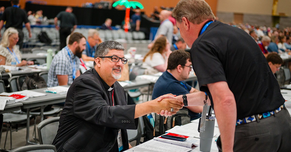 The Rev. Dr. Alfonso O. Espinosa is congratulated by the Rev. Robert (Bob) Pase upon being elected to serve as LCMS third vice-president. (LCMS/Erik M. Lunsford)